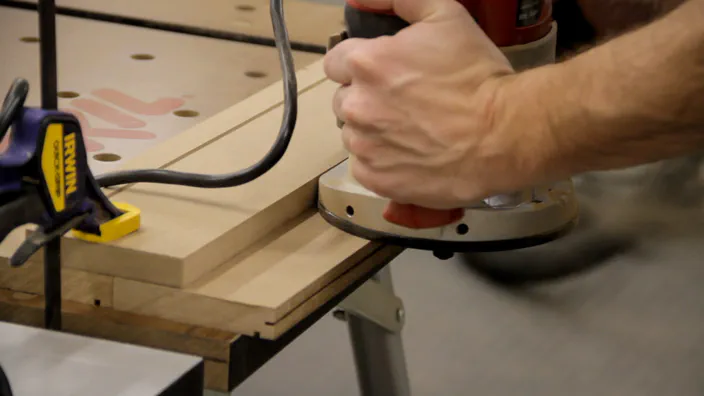 A slot is cut along a MDF edge using a router.