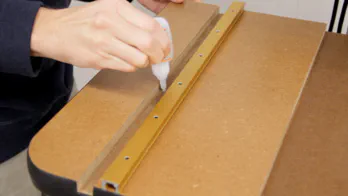 Super glue is applied to the t-track grooves.