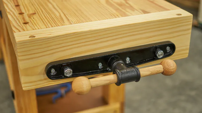 A quick release end vise on a workbench.