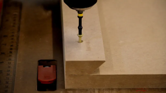 A screw is used to attach an MDF cleat to the back.