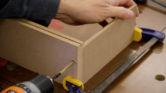 A screw is used to attach the MDF inner side to the bottom.