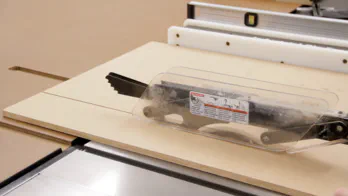 A table saw is used to cut a large sheet of MDF.