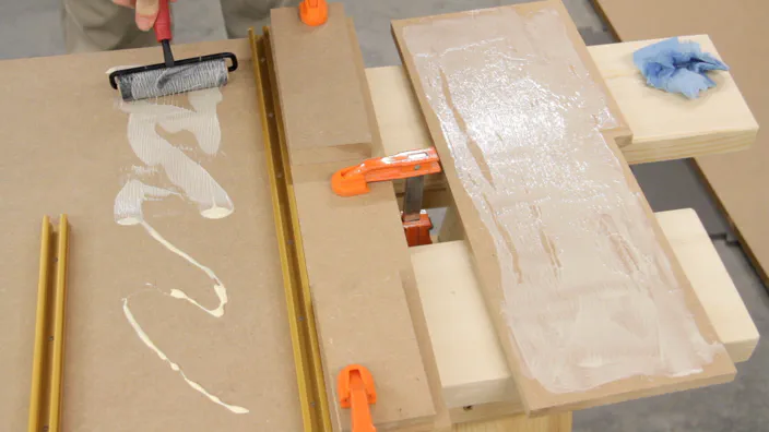Glue is applied to pieces of MDF.