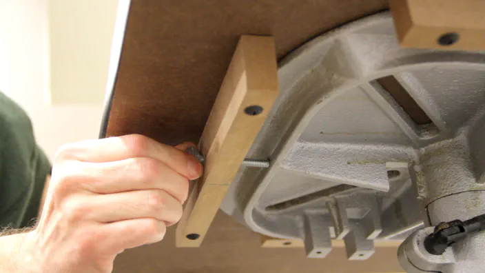 A thumbscrew is used to secure the table to the drill press.