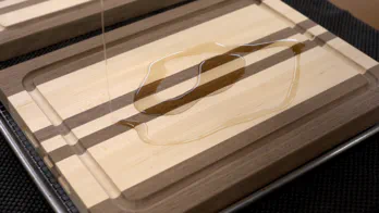 Mineral oil is applied to an edge grain cutting board.
