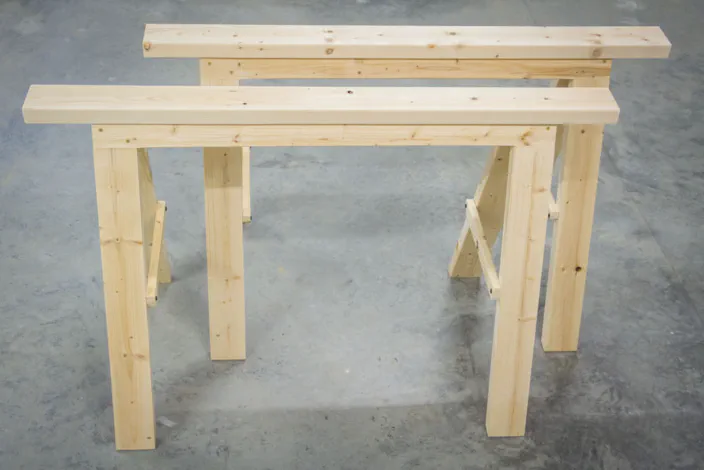A pair of wooden folding sawhorses.