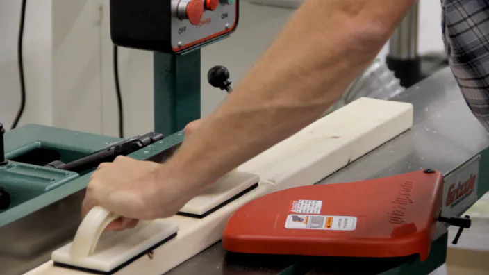 A power jointer is used to join a 2x4.
