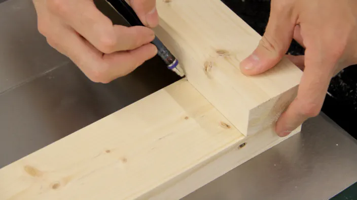 A pencil is used to mark the first half of a lap joint.
