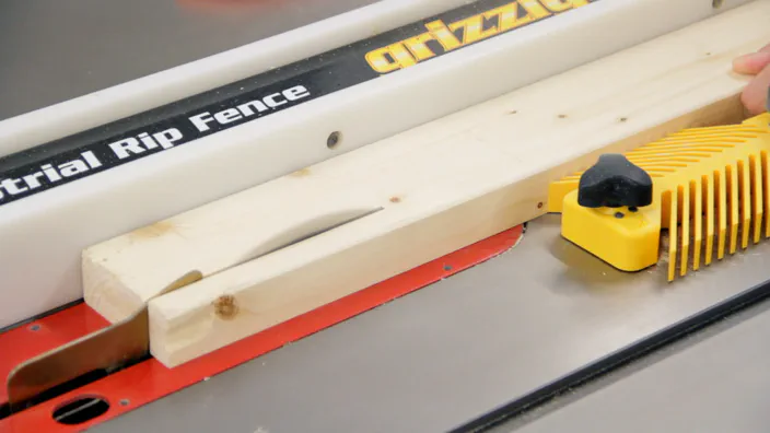 A table saw is used to rip a 2x4.