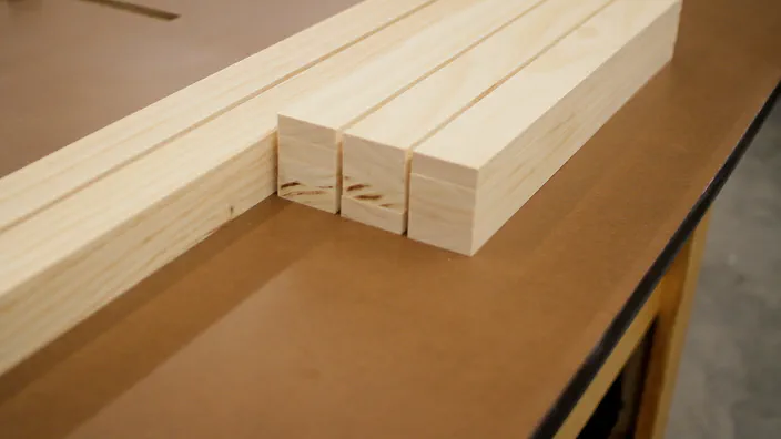 Several cut pieces of pine wood are stacked together.