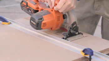 A circular saw is used to cut a large sheet of MDF.
