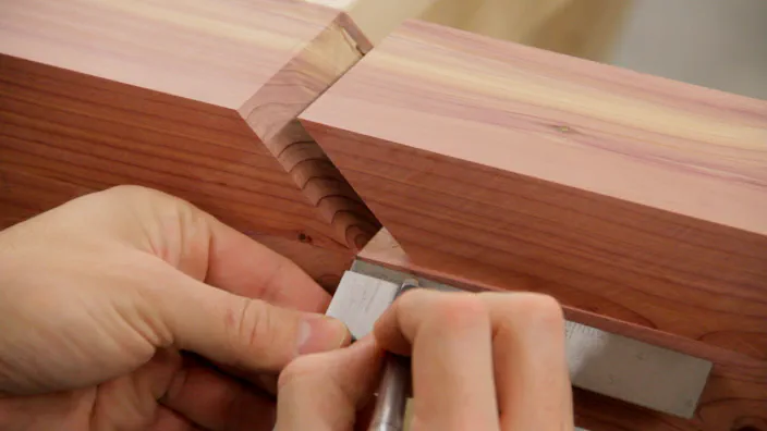 A ruler is used to mark the spacing between each cedar part.