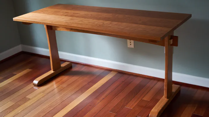 A trestle desk made of cherry wood.