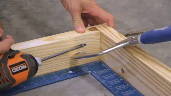 A pocket hole clamp and drill are used to screw together the frame.