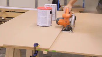 A circular saw is used to cut a piece of MDF.