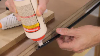 Glue is applied to the inside of a piece of T-molding