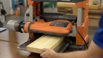 A planer is used to flatten a board.