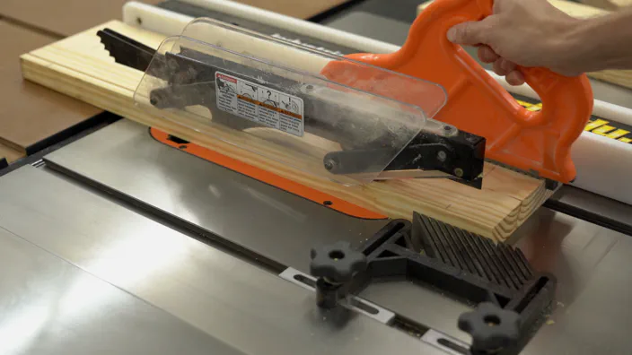 A table saw is used to rip a board to width.