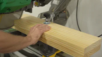 Two boards are cut together at the miter saw