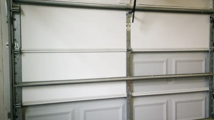 Several pieces of insulation installed in a garage door.