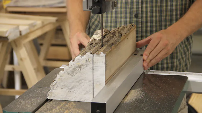 A quartered log is cut at the bandsaw.